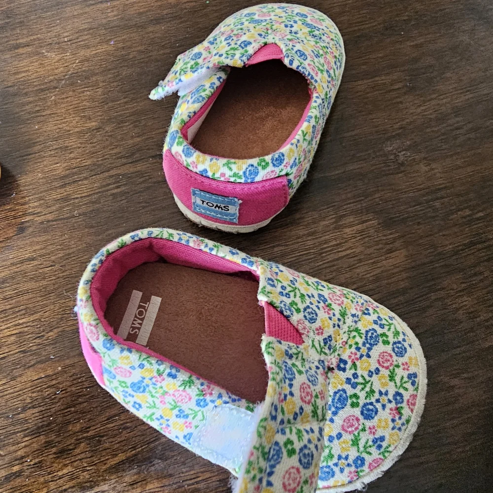 3 pairs of baby/girl shoes—soft, floral, and glittery—in various styles.